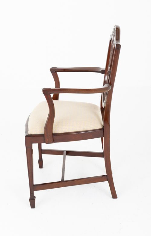 A set of ten mahogany Hepplewhite style dining chairs with shield backs and cream patterned upholstered seats. View V