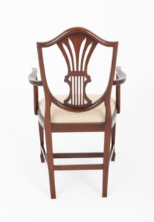 A set of ten mahogany Hepplewhite style dining chairs with shield backs and cream patterned upholstered seats. View VI