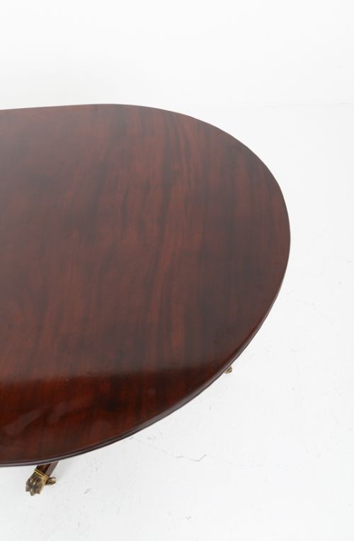 fig 2. A large Regency Revival dark mahogany three-pedestal dining table with reeded splayed legs and brass claw castors.