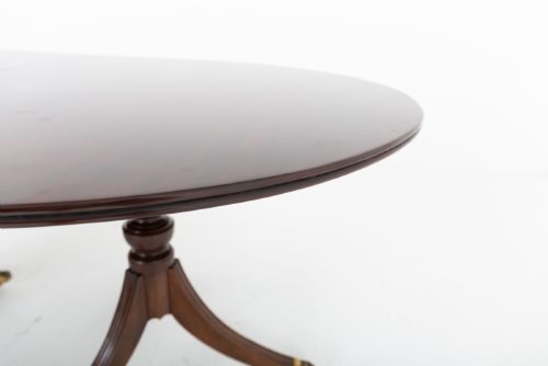 fig 3. A large Regency Revival dark mahogany three-pedestal dining table with reeded splayed legs and brass claw castors.