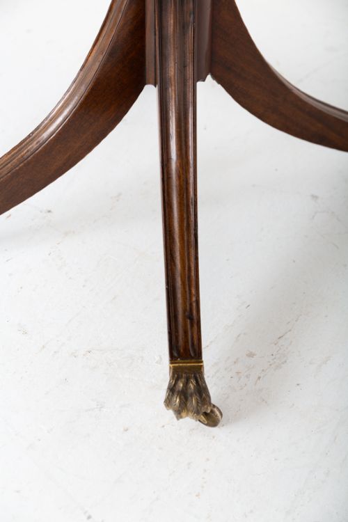 A large Regency Revival dark mahogany three-pedestal dining table with reeded splayed legs and brass claw castors. View VII