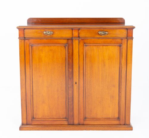 fig 1. A Victorian mahogany side cabinet featuring two top drawers with brass drop handles above two panelled cupboard doors and a low top gallery.