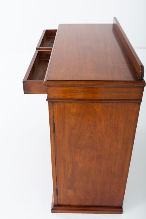 A Victorian mahogany side cabinet featuring two top drawers with brass drop handles above two panelled cupboard doors and a low top gallery. View VI