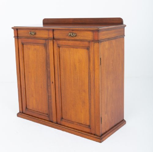 A Victorian mahogany side cabinet featuring two top drawers with brass drop handles above two panelled cupboard doors and a low top gallery. View VIII