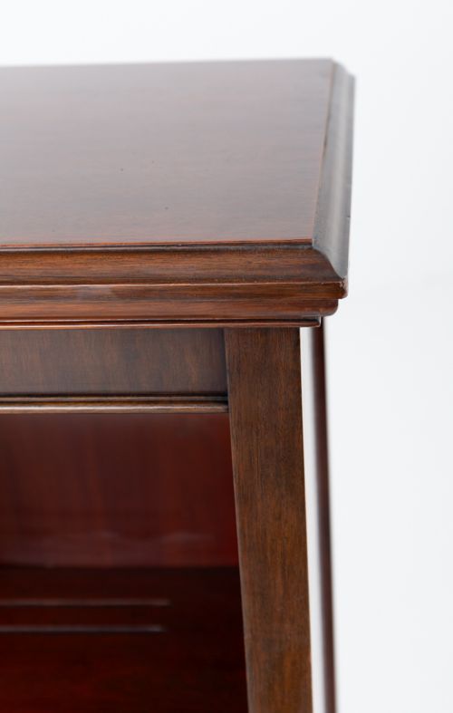 A wide Victorian open mahogany bookcase featuring a panelled back, two horizontal shelves, and turned feet. View V