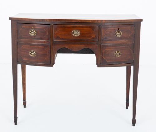 fig 1. An antique Georgian bow-fronted mahogany sideboard with drawers featuring brass oval drop handles and tapered square legs.