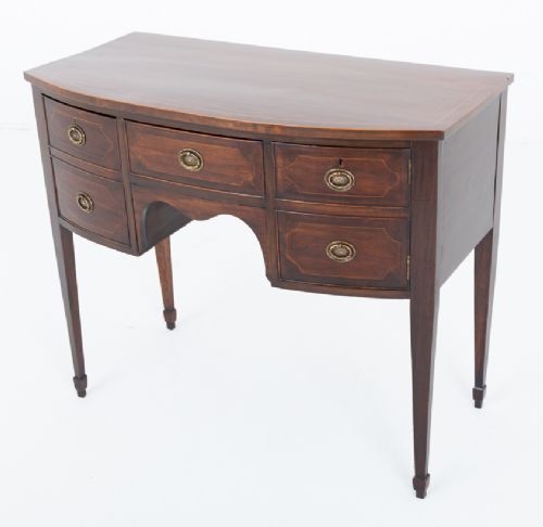 An antique Georgian bow-fronted mahogany sideboard with drawers featuring brass oval drop handles and tapered square legs. View VIII