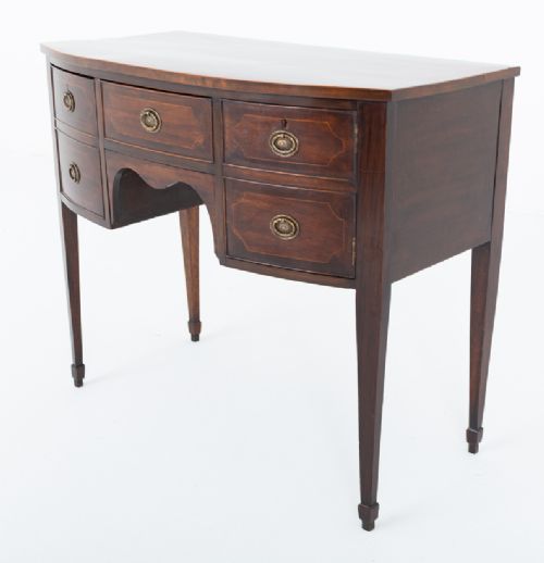 An antique Georgian bow-fronted mahogany sideboard with drawers featuring brass oval drop handles and tapered square legs. View IX