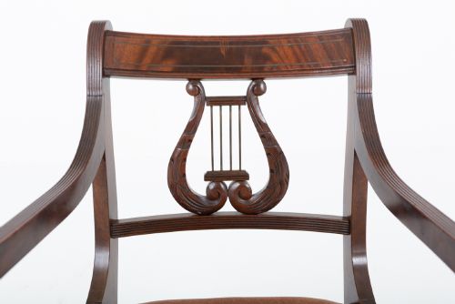 fig 3. A set of ten mahogany Regency style dining chairs featuring carved lyre back splats, curved armrests on two carvers, and rust-coloured upholstered seats.