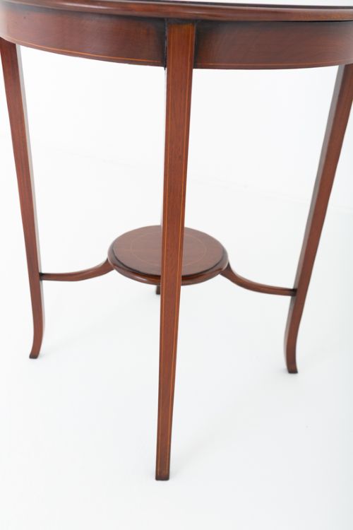 A circular mahogany occasional table featuring four flared legs joined by a central lower circular tier. View IV