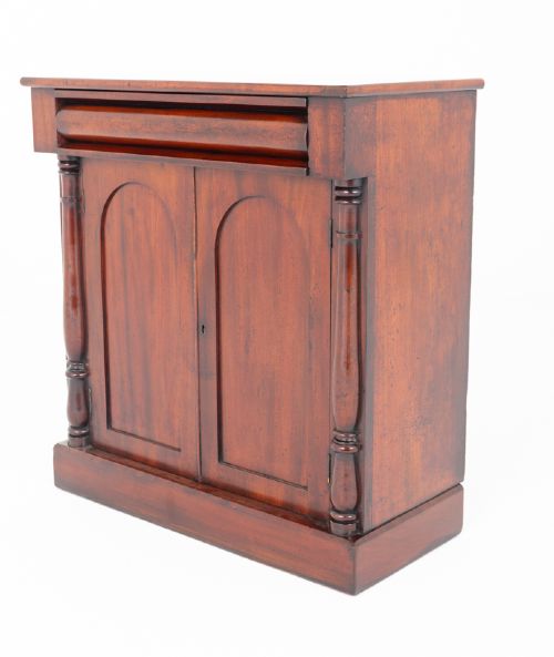 A Victorian mahogany side cabinet featuring two arched panel doors, turned side columns, a top frieze drawer, and a solid plinth base. View III