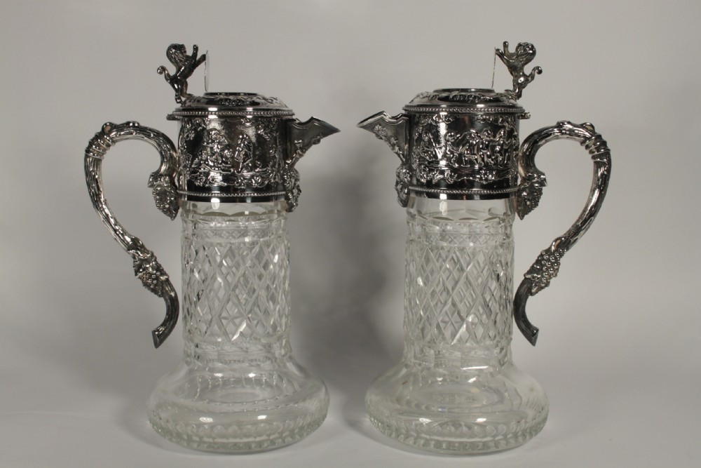 A Pair of Cut Glass and Silver Plate Portuguese Claret Jugs