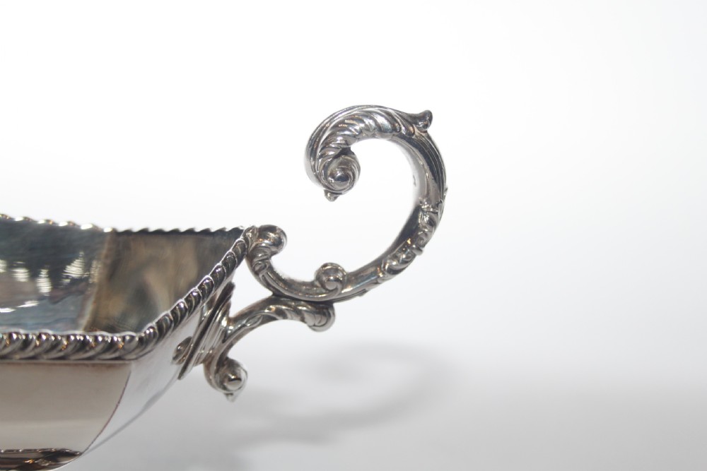 A pair of silver plated sauce boats with pedestal bases, scroll handles, and rope twist borders. View II