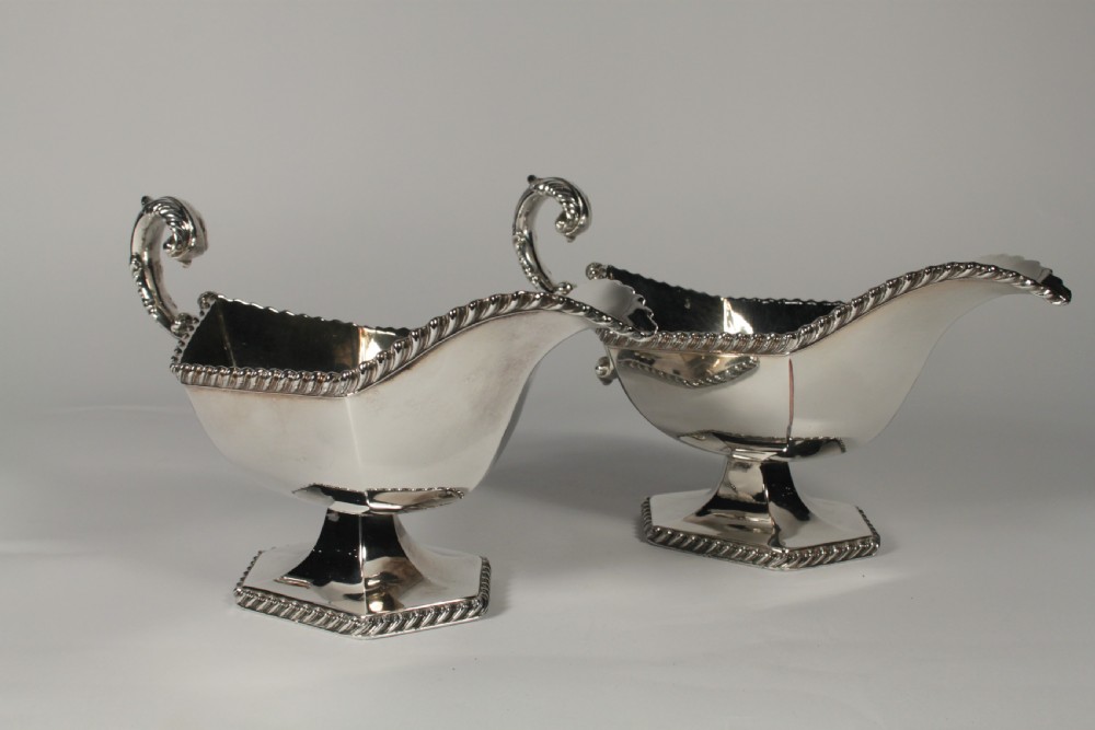 A pair of silver plated sauce boats with pedestal bases, scroll handles, and rope twist borders. View III