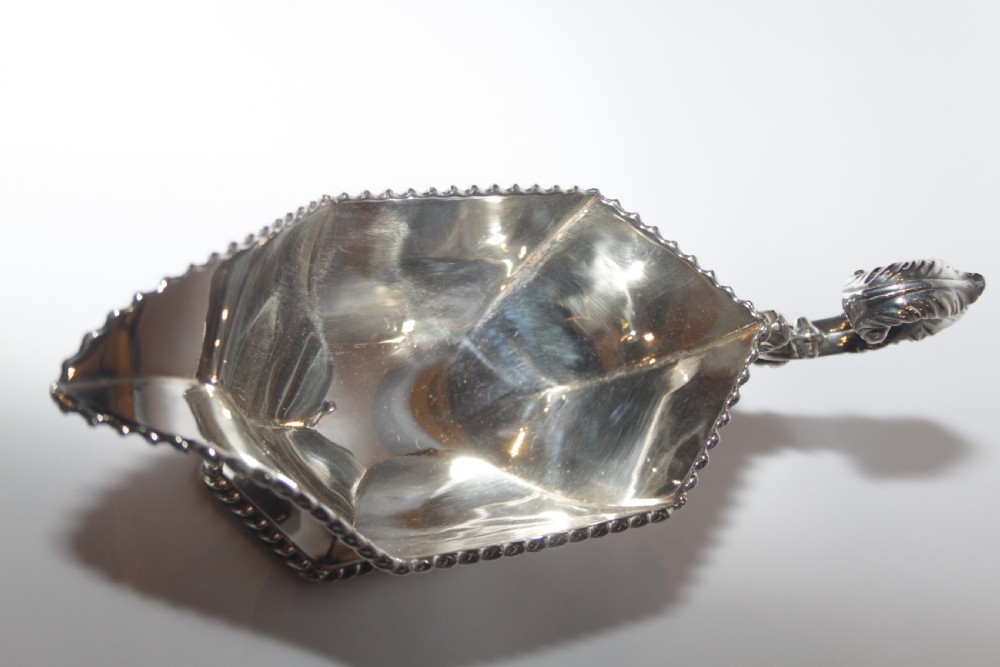 A pair of silver plated sauce boats with pedestal bases, scroll handles, and rope twist borders. View VI