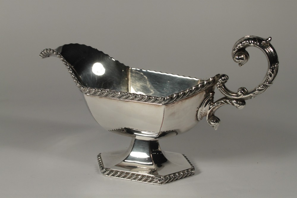 A pair of silver plated sauce boats with pedestal bases, scroll handles, and rope twist borders. View VIII