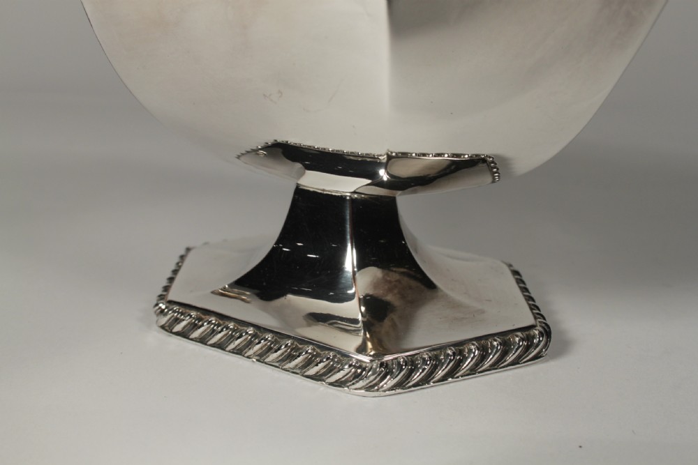 A pair of silver plated sauce boats with pedestal bases, scroll handles, and rope twist borders. View IX