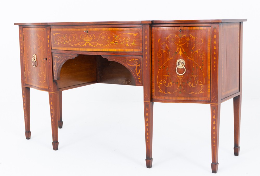 A Sheraton Revival mahogany sideboard featuring intricate floral marquetry inlay, a central drawer, flanking cupboard doors, and square tapered legs.