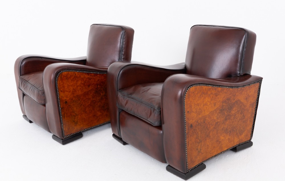 A pair of Art Deco club chairs upholstered in brown leather with burr walnut side panels and studded trim. View III