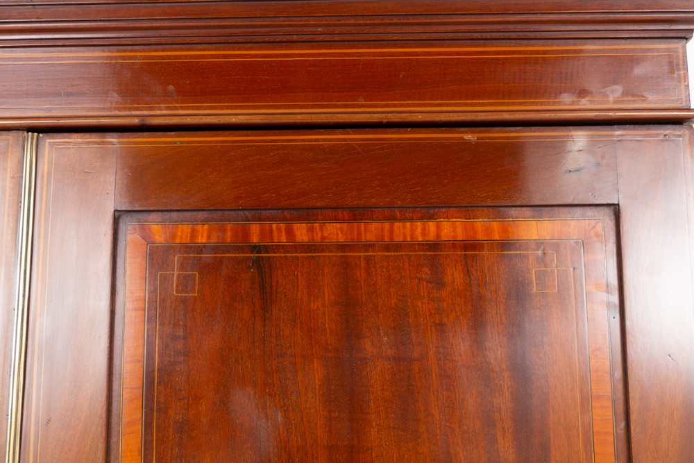 A tall Sheraton Revival mahogany two-door wardrobe featuring inlaid panelled doors, a lower base drawer, and bracket feet. View III