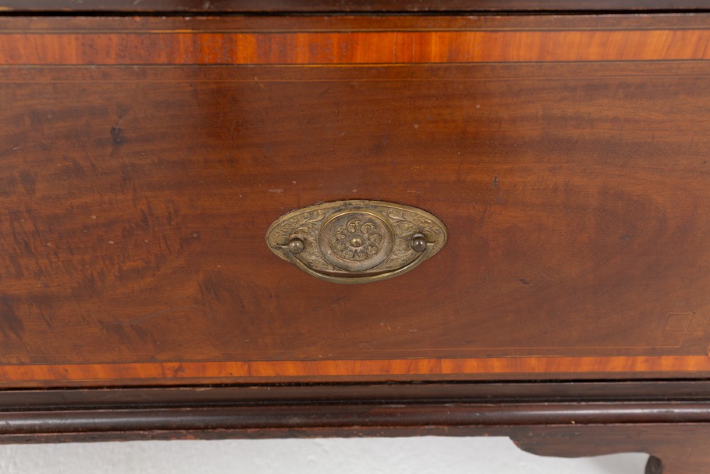 A tall Sheraton Revival mahogany two-door wardrobe featuring inlaid panelled doors, a lower base drawer, and bracket feet. View V