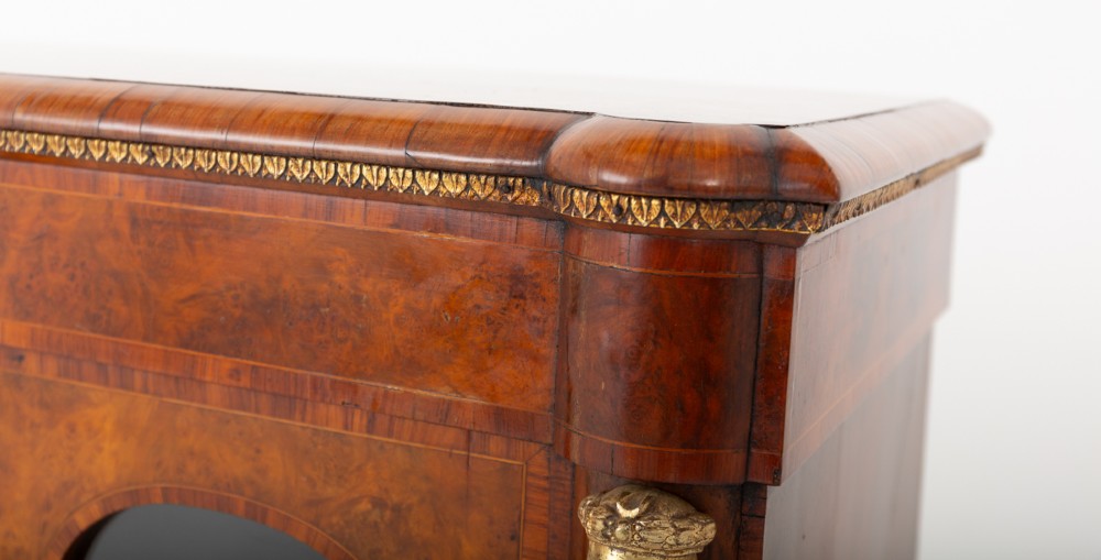 A Victorian burr walnut credenza featuring three arched glazed doors, intricate gilt ormolu mounts, and a solid plinth base. View IV
