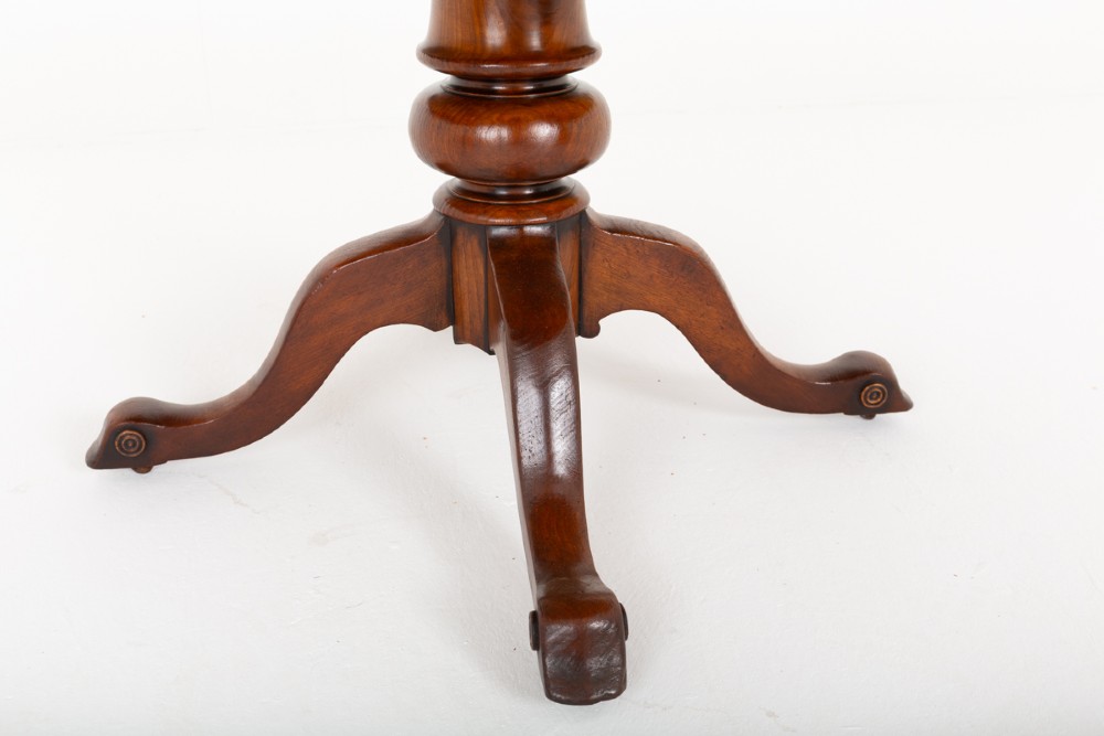 An antique Victorian mahogany extending dining table featuring an oval top, removable centre leaf, and a carved central pedestal base with splayed legs. View III