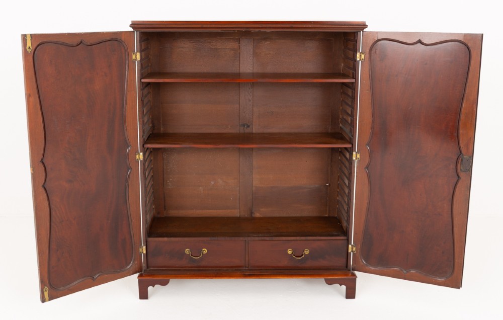 A Georgian mahogany side cabinet featuring two cupboard doors with shaped panel mouldings, brass escutcheons, and bracket feet. View III