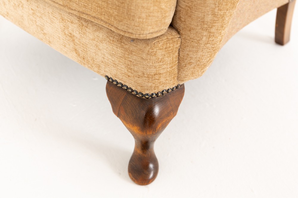 A pair of Georgian style wingback armchairs with tan textile upholstery, hump backs, shaped side wings, and walnut cabriole front legs. View V