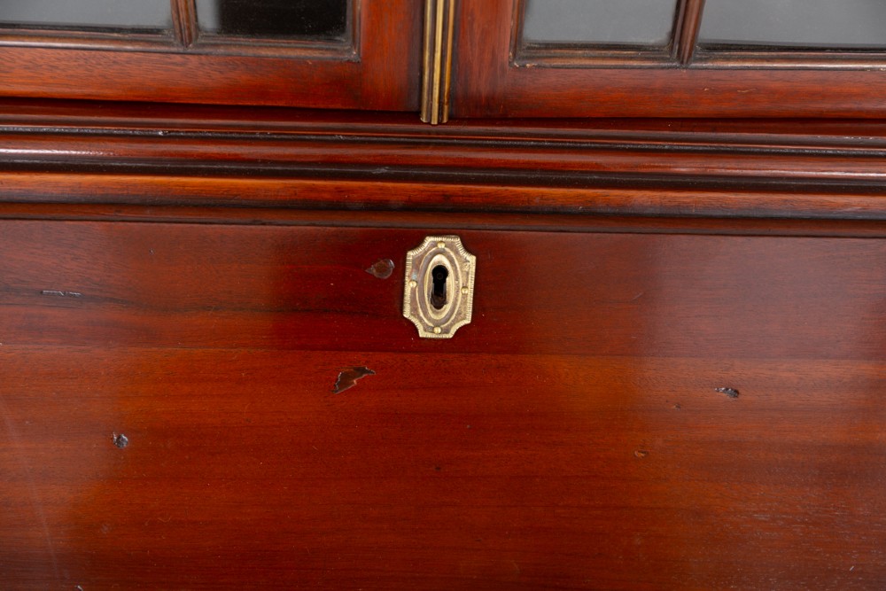 A Georgian mahogany bureau bookcase featuring an upper cabinet with astragal glazed doors, a slant-front writing slope, four graduated drawers, and bracket feet. View VI