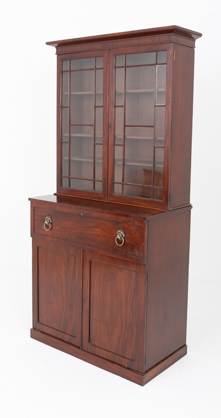 A William IV mahogany secretaire bookcase featuring an upper cabinet with astragal glazed doors, a pull-down secretaire drawer with brass lion mask handles, and a lower two-door cupboard. View IX