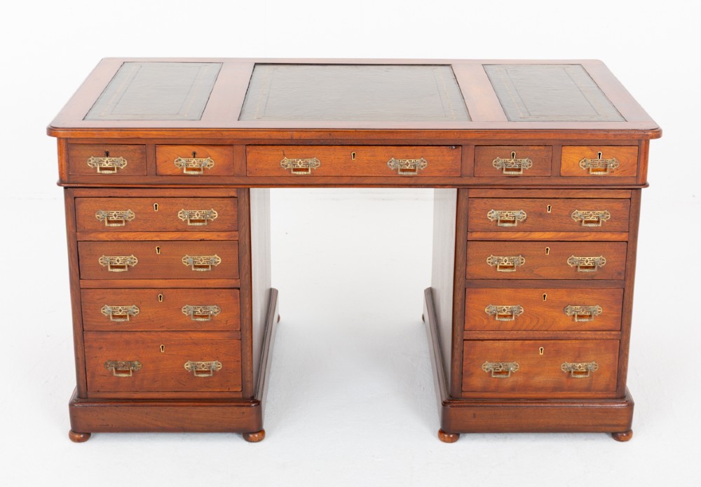 A Victorian mahogany pedestal desk featuring a green leather inset writing surface, multiple drawers with brass handles, and a plinth base. View II