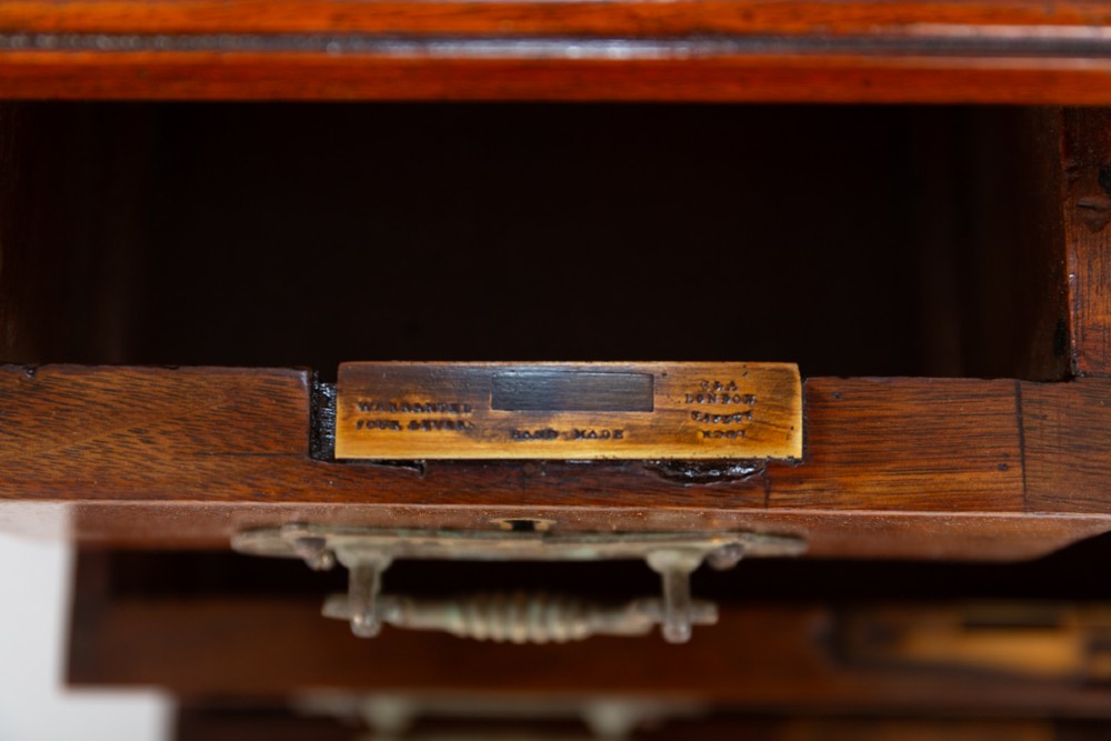 A Victorian mahogany pedestal desk featuring a green leather inset writing surface, multiple drawers with brass handles, and a plinth base. View V