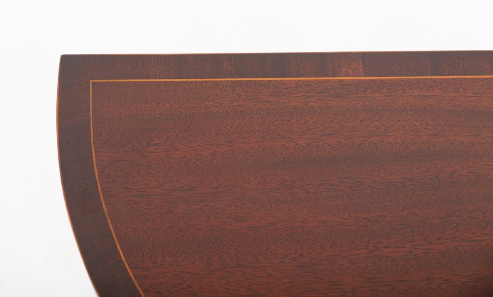 A semicircular mahogany demi-lune console table featuring decorative wood inlay along the apron and top edge, supported by four slim tapered square legs. View II