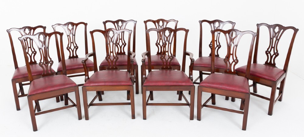 A set of ten mahogany Chippendale style dining chairs with carved pierced back splats and red upholstered seats. View II