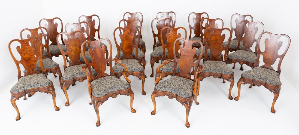 A large set of twenty Queen Anne style elm dining chairs featuring shaped vasiform back splats, upholstered patterned seats, and cabriole legs with carved shell details. View II