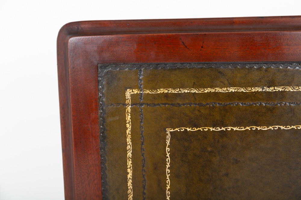 A Victorian mahogany partners writing table featuring a green leather inset top, turned legs on brass castors, and drawers with wooden knob handles. View IX