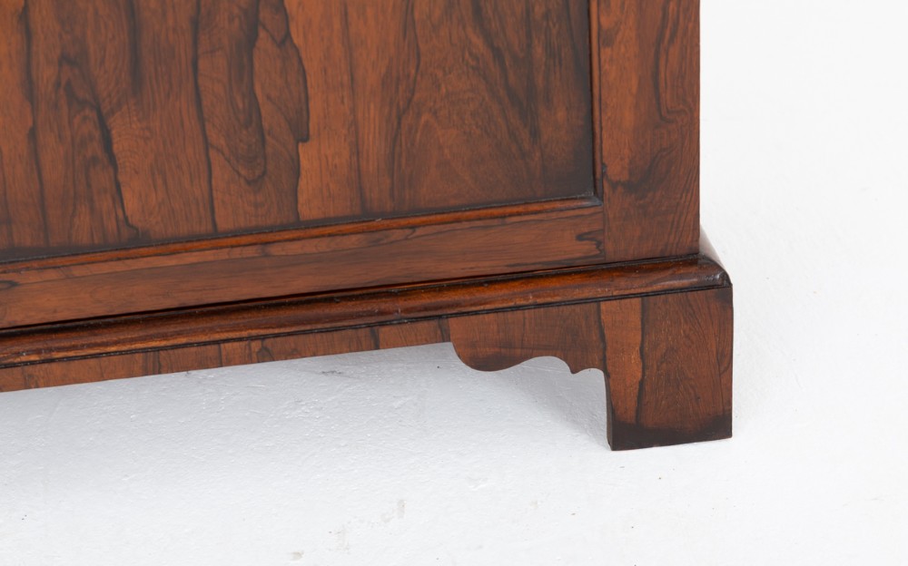 A William IV rosewood glazed bookcase featuring Gothic arched glazing bars on the upper double doors above a two-door solid cabinet base. View IV
