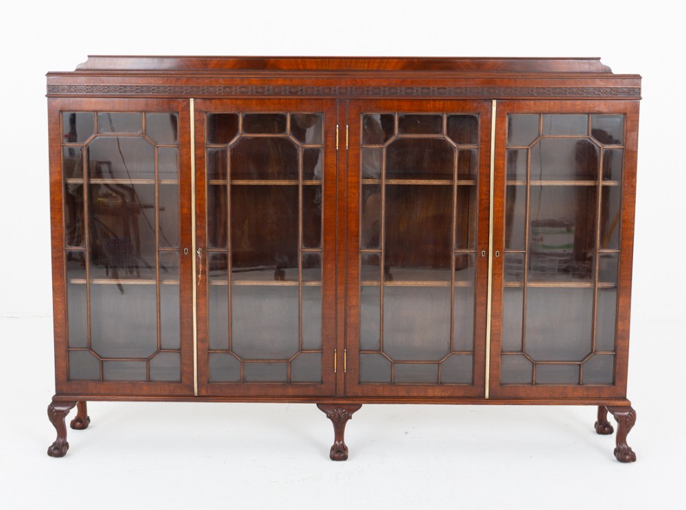 A low mahogany four-door side cabinet featuring geometric astragal glazed glass panels and carved claw and ball feet. View III