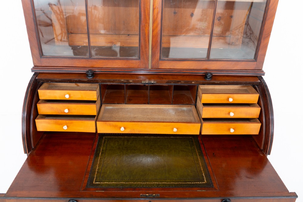A Regency mahogany cylinder bureau bookcase featuring Gothic astragal glazed upper doors above a curved roll-top desk and three long drawers with turned dark handles. View VI