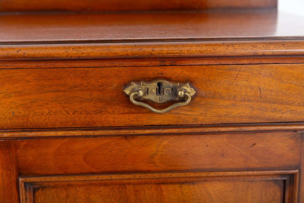 A Victorian mahogany side cabinet featuring two top drawers with brass drop handles above two panelled cupboard doors and a low top gallery. View IV