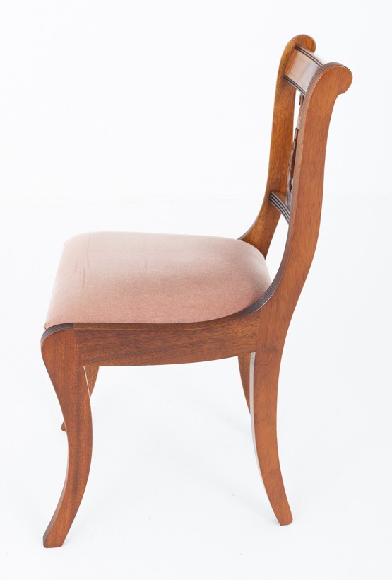 A set of ten mahogany Regency style dining chairs featuring carved lyre back splats, curved armrests on two carvers, and rust-coloured upholstered seats. View XI