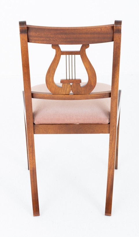 A set of ten mahogany Regency style dining chairs featuring carved lyre back splats, curved armrests on two carvers, and rust-coloured upholstered seats. View XII