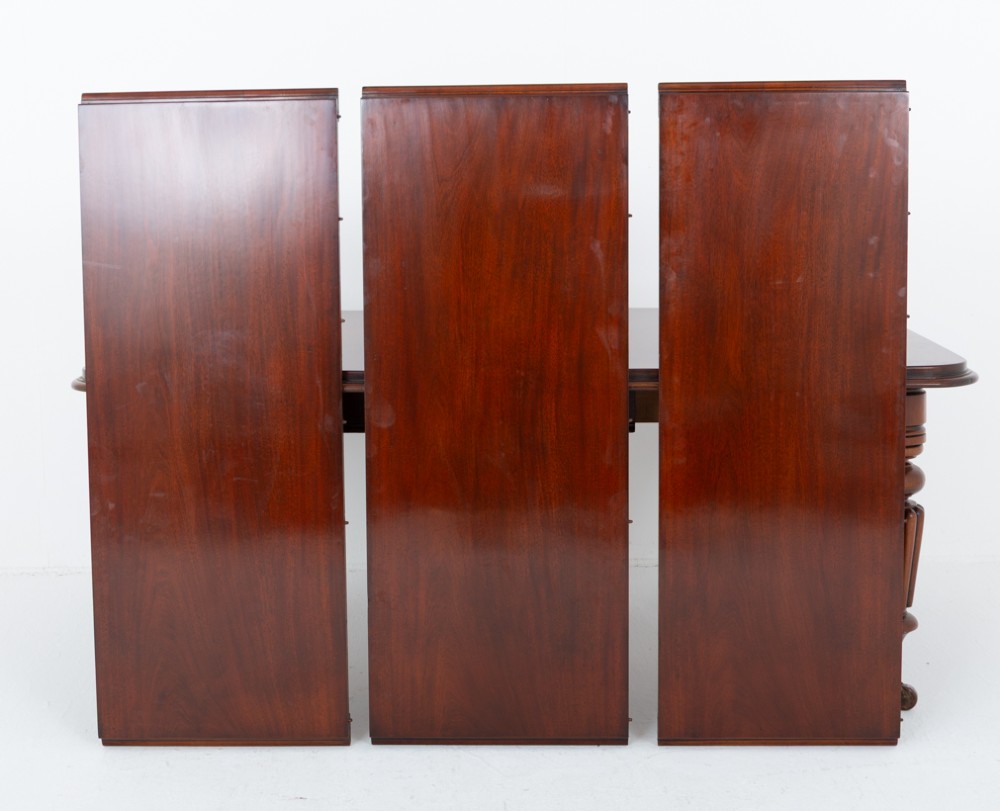 A William IV mahogany extending dining table with three additional leaves, standing on turned and reeded legs with brass castors. View XI