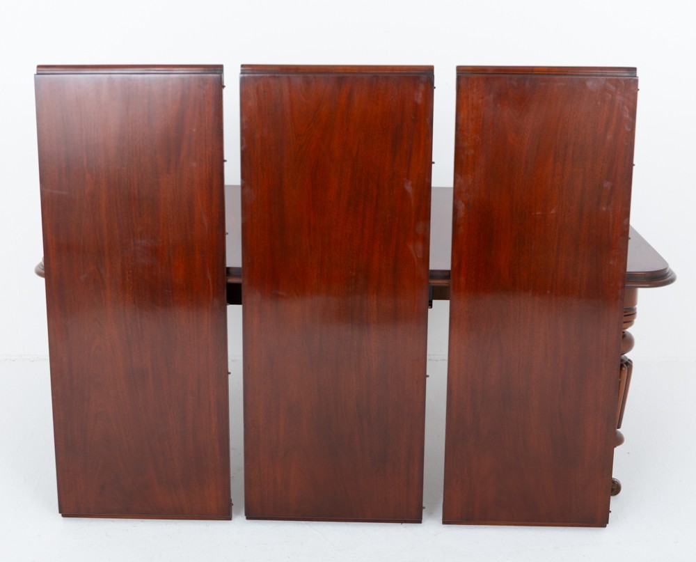 A William IV mahogany extending dining table with three additional leaves, standing on turned and reeded legs with brass castors. View XII