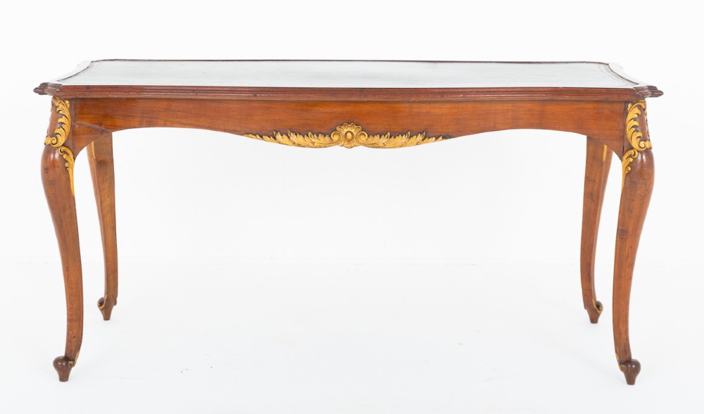 A mahogany centre writing table with cabriole legs, gilded rococo mounts on the frieze and knees, and a dark green leather inset surface. View II