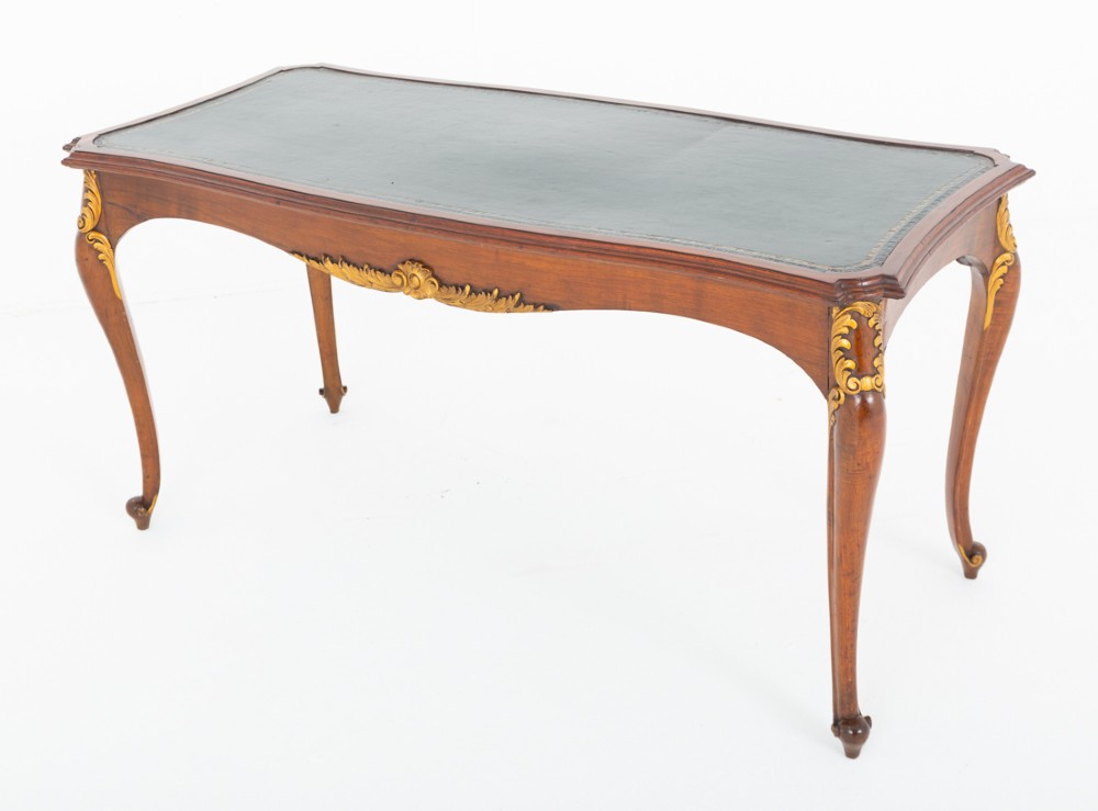 A mahogany centre writing table with cabriole legs, gilded rococo mounts on the frieze and knees, and a dark green leather inset surface. View V