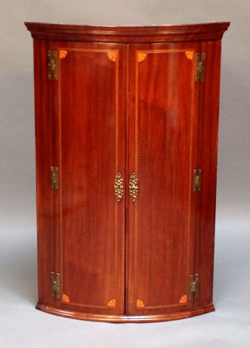 A Georgian Bow Fronted Corner Cupboard