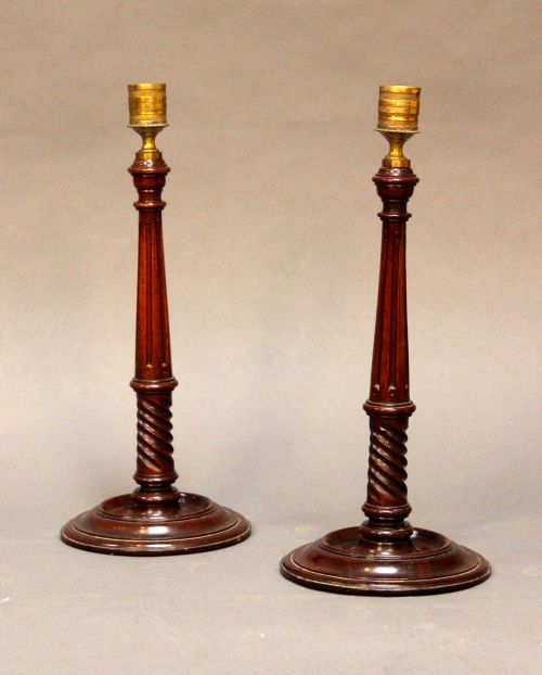 A Pair of 19thc. Mahogany Turned
& Fluted Candlesticks