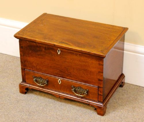 A 19th-century miniature walnut mule chest featuring visible dovetail joinery, a hinged top lid, a single lower drawer with decorative brass handles, and bone keyhole escutcheons. View III